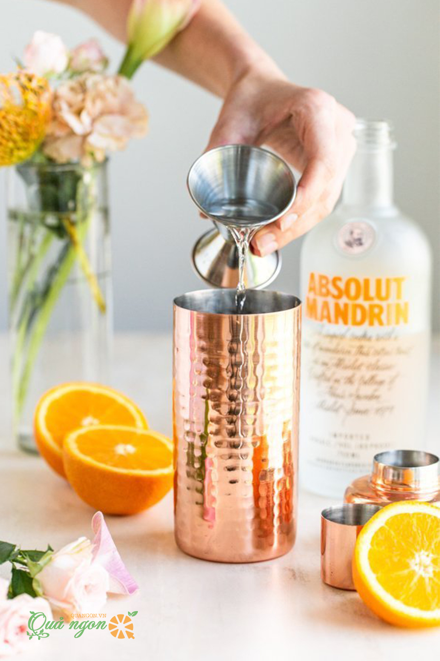 Đổ rượu vodka cam và Triple sec vào bình lắc cocktail